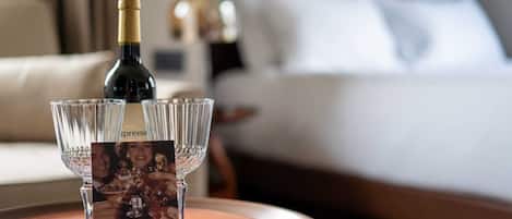 A bottle of champagne and four glasses on a tray, with a brochure in front.