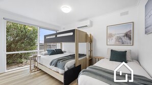 A modern bedroom with a bunk bed, a single bed, and a large window with a view of greenery. - Albany Beachside Retreat *1 NIGHT FREE* (Sorrento)