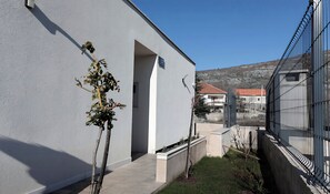 Stylish building with a simple design and a small tree in the foreground.