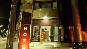 A hotel with a modern design, featuring a prominent 'HOTEL' sign and a multi-story structure with balconies. - Nordeste Palace Hotel - Glória/SE (Nossa Senhora Da Gloria)