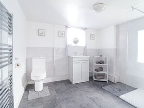 A modern bathroom with a toilet, sink, and shower. - Minffordd (Abergele)