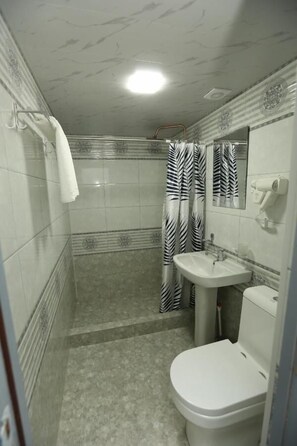 Douche, sèche-cheveux, chaussons, serviettes fournies