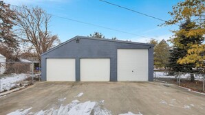 Un bâtiment d’un seul étage, doté d’une porte de garage et d’une allée couverte.