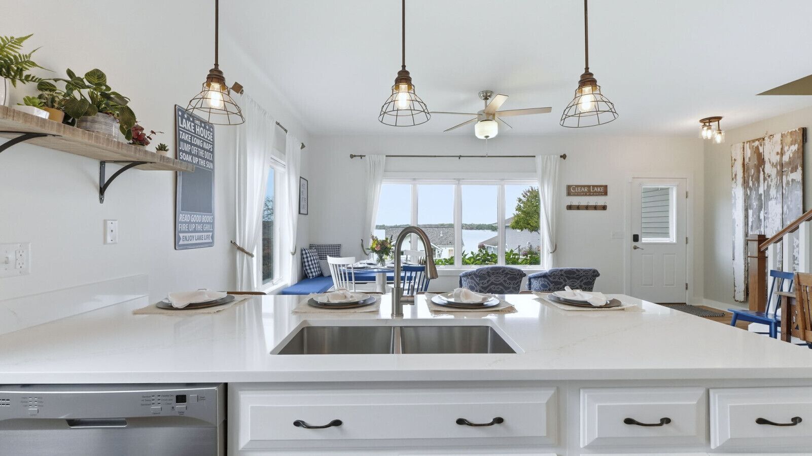 Open-concept dining room with comfortable seating positioned to overlook the lake, offering a relaxed setting for meals with a view.