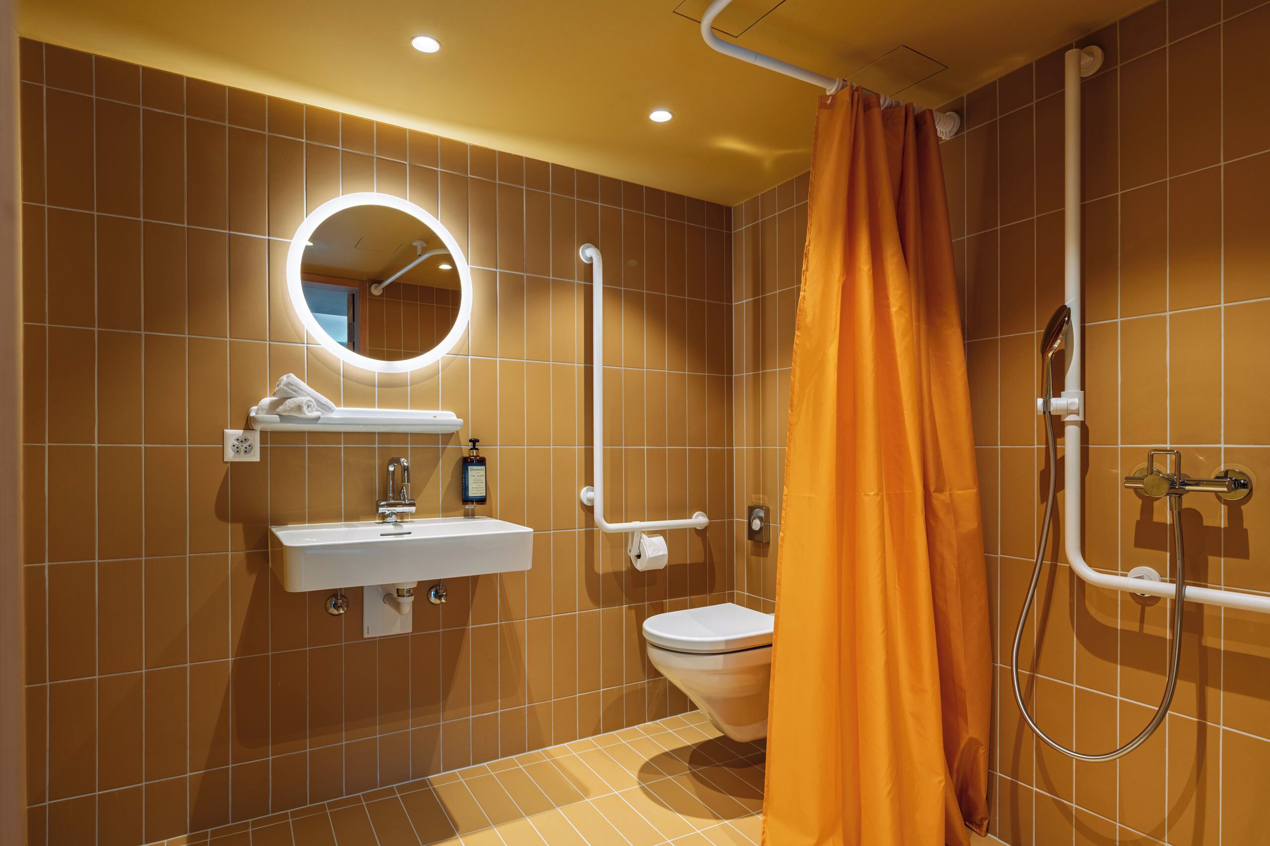 A bathroom with a sink, toilet, and shower.