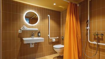 A bathroom with a sink, toilet, and shower.