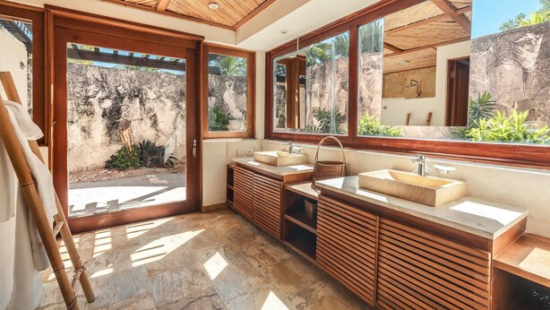 A modern bathroom with a large window, two sinks, and a wooden vanity. - Bungallow Private Pool 4 Guests Cap Cana (Punta Cana)