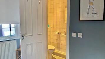 Shower, hair dryer, towels, toilet paper