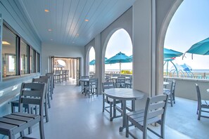 Enjoy meals in a spacious dining area with tables and chairs arranged for easy movement and interaction, offering views of the surrounding area.