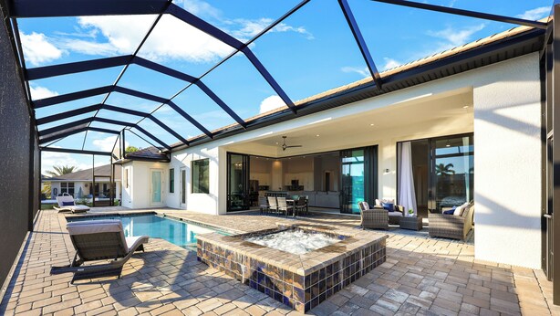 A modern outdoor living area with a pool, hot tub, and seating. - Surfside Villa ~ Entire home in Cape Coral, Florida (Cape Coral)