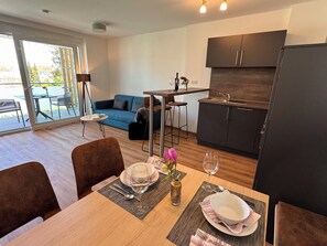 Comfort Apartment, Garden View | Living area | 32-inch Smart TV with cable channels