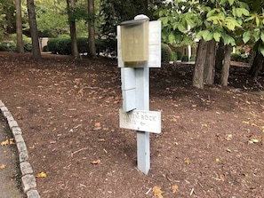 A wooden signpost with a mailbox and a trail sign for the Raven Rock Trail. - The Best of the Greenbrier (White Sulphur Springs)