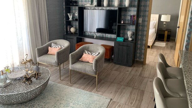 A modern living room with two armchairs, a coffee table, and a TV wall unit. - RL2 504 in Santo Domingo de Guzm n (Santo Domingo)