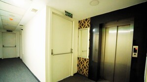 A hallway with an elevator and a door marked "Crisis Exit." - Polo Suit Otel (Istanbul)