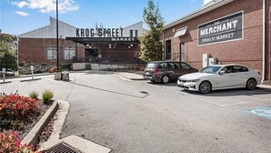 A building with signs reading "Krog Street Market" and "The Merchant Krog St Market".