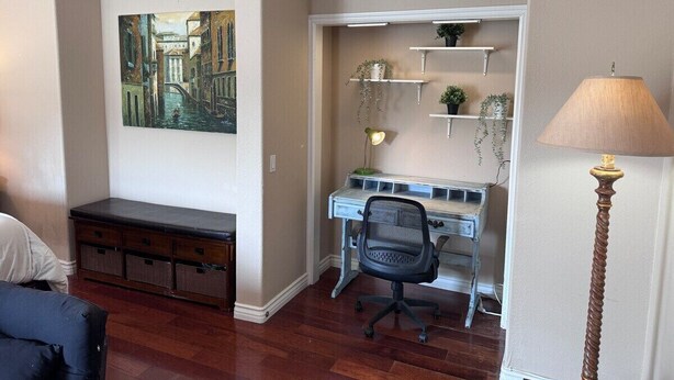 A compact room with a desk, chair, and a bench. There is a painting on the wall and a lamp on the floor. - Studio in QUIET  SFR home, gated community. (Laguna Niguel)