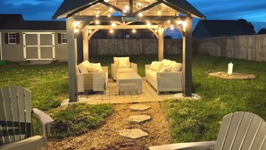 A covered patio area with wicker furniture and a sign reading "EASTVILLE".