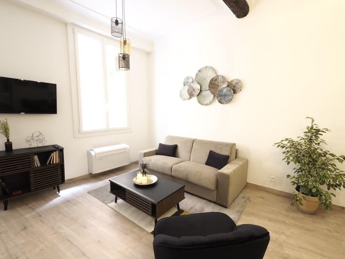A modern living room with a sofa, coffee table, and a TV.