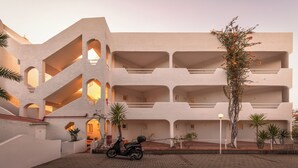 A multi-level building with balconies, a scooter, and a street lamp. - Outsite Vilamoura - Work, Connect, Explore (Loule)