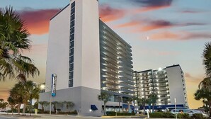 A multi-story hotel with a prominent white facade and a balcony on the upper floors. - Bluewater Resort 1501 (Myrtle Beach)