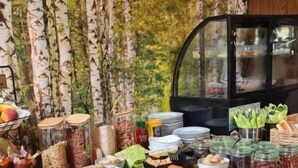 A buffet table with various food items and a glass display case in the background. - LuxArt City SPA Residence Krk (Krk)