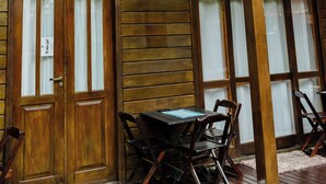 A reception area with wooden walls, a reception desk, and a staircase leading to an upper level.
