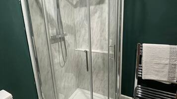 Shower, towels, soap, toilet paper