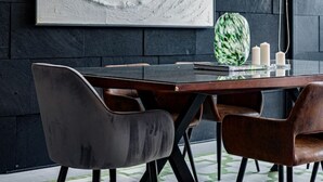 A modern dining area with a dark wall, a large abstract painting, a wooden table, and black chairs. - Bright, Stylish Retreat w/ Private Balcony & WiFi (Ciudad de México)