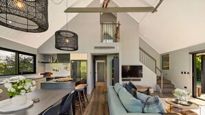 A modern interior with a kitchen, dining area, and living room.
