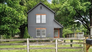 A two-story house with a grey exterior, white window shutters, and a wooden door. - Cozy Urban Getaway - 3BR 1.5BA - 7 Mins to Downtown CLT (Charlotte)