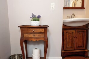 A wooden vanity with a white sink and a mirror above it. - Riverbend Retreat - Hot Tub and Tastings Included (Healdsburg)