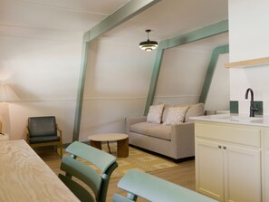 Deluxe Suite, 2 Bedrooms, Pool View | Living area | 27-inch TV with cable channels