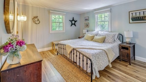 A bedroom with a bed, bedside tables, a mirror, and a window. - Classic Cape Cod Escape: Beaches and Backyard BBQs (Wellfleet)