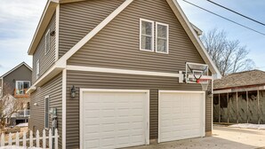 A two-story house with a garage, a basketball hoop, and a white picket fence. - Close to Trails & Town! Artsy Apt in Frankfort (Frankfort)