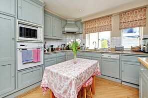 Enjoy cooking in this well-equipped kitchen with a central island, microwave, and oven.