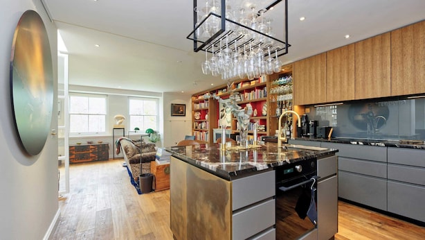 A modern kitchen with a central island, built-in appliances, and a wine rack. - Stunning 2 Bedroom Apartment in Little Venice West London (London)