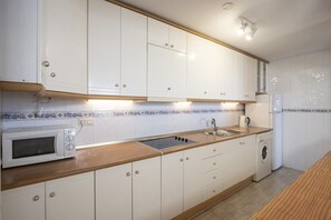 Fridge, microwave, coffee/tea maker, cookware/dishes/utensils