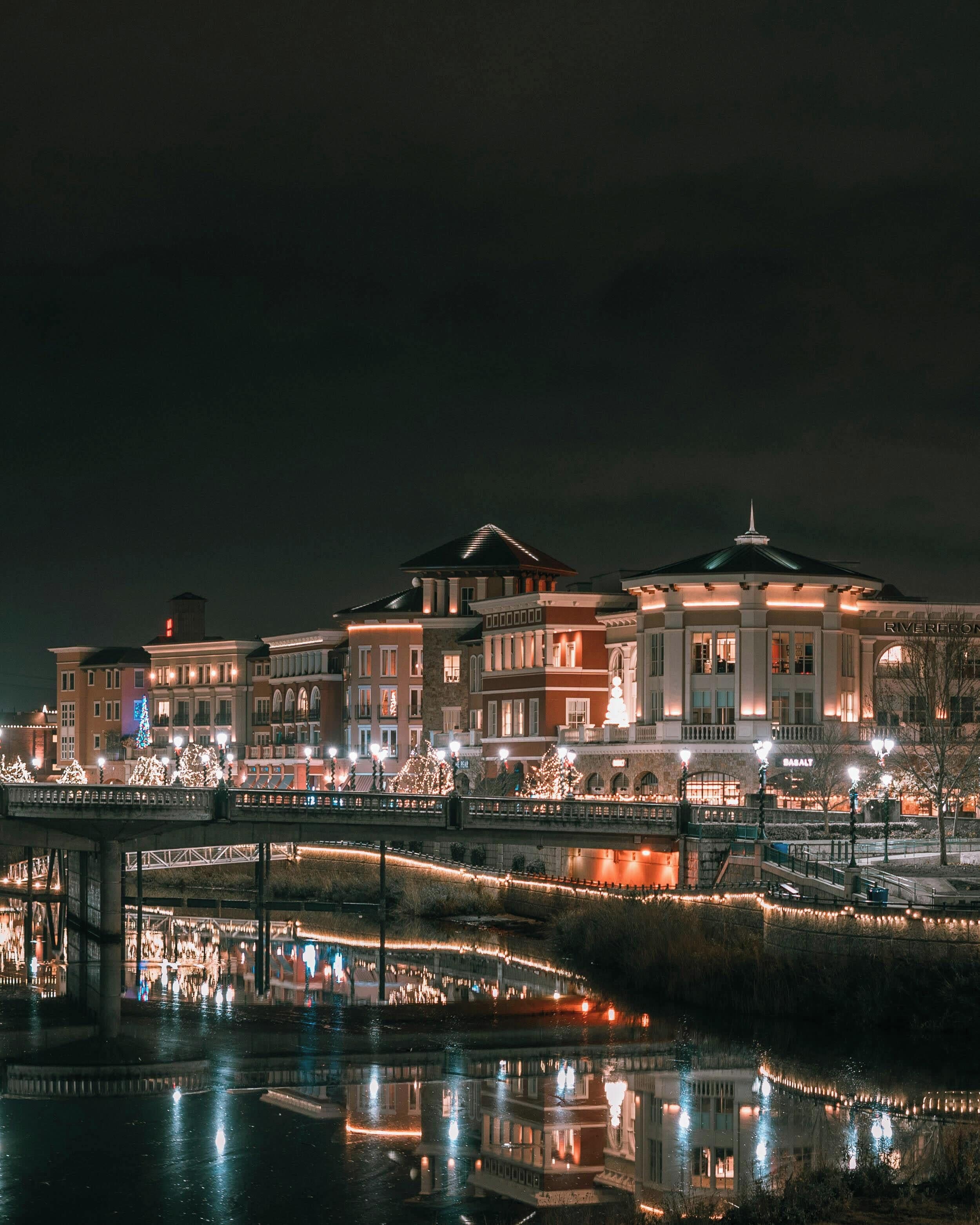 A large hotel with multiple buildings, a bridge, and a river.