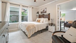 A bedroom with a bed, nightstand, and a ceiling fan. - SoCo Austin Home & Cowboy Charm (Austin)