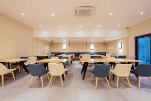A dining area with tables and chairs, recessed lighting, and a view through a window. - Lechao Collection Hotel (Shanghai Bailian Central Zhenguang Road Subway Station) (Shanghai)