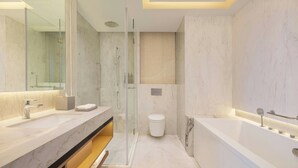 A modern bathroom with a large mirror, two sinks, a shower enclosure, and a bathtub.