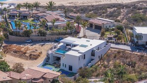 A coastal resort with multiple buildings, a swimming pool, and a beach. - Villa Maravilla at Pedregal (Cabo San Lucas)