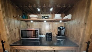 A compact kitchen with a microwave, coffee maker, and a shelf with dishes and a sign. - Exclusive 2 Bedroom Garden Level Apartment in Lovely Littleton Colorado! (Littleton)