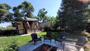 A backyard with a fire pit, outdoor furniture, and a wooden structure. - Exclusive 2 Bedroom Garden Level Apartment in Lovely Littleton Colorado! (Littleton)