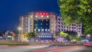 A hotel with a modern facade, large windows, and a prominent signage.