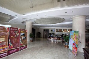 A spacious lobby with marble flooring, large columns, and informational posters. - Saiyan Hotel (Zhongshan Bus Terminal) (Zhongshan)