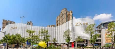 A modern building with a curved facade, a prominent McDonald's sign, and a clear blue sky.
