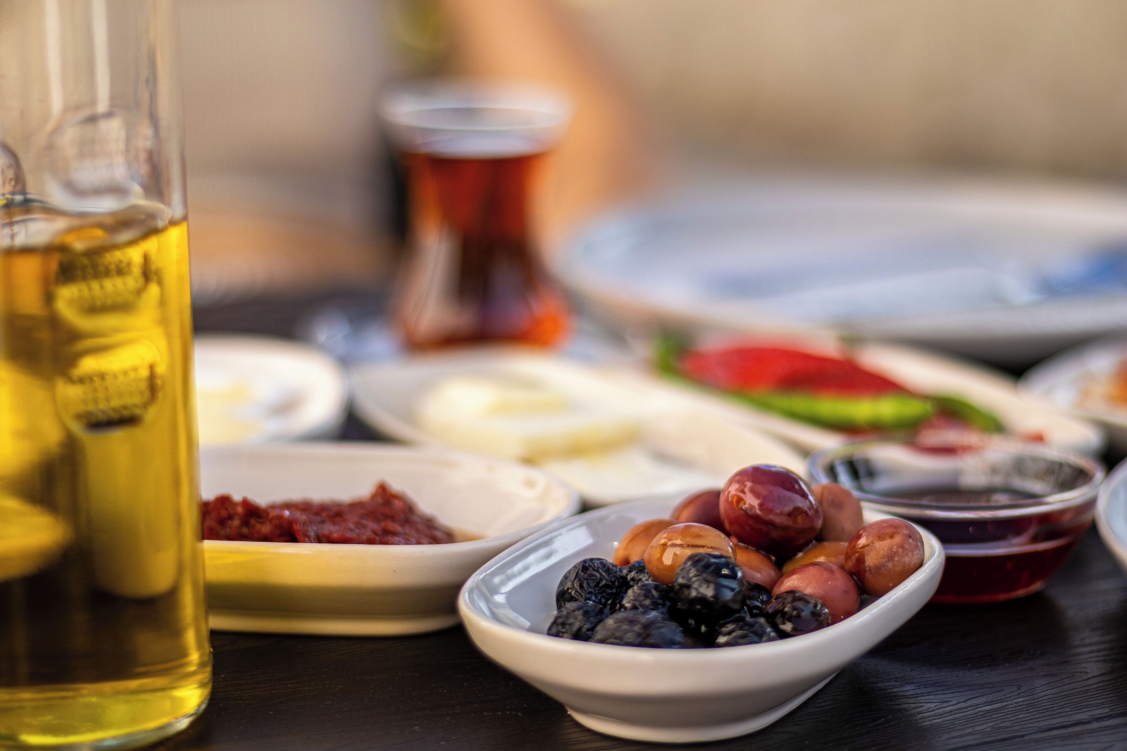 A table with various food items and a bottle of liquid.