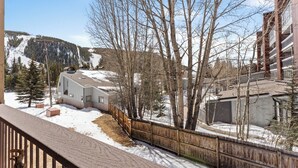 A residential area with a house, a wooden fence, and a mountain in the background. - Sdc204a-1 (Keystone)