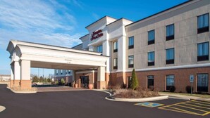 A hotel with a modern facade, a covered entrance, and a parking area with handicapped accessibility. - Hampton Inn & Suites LLC (Danville)